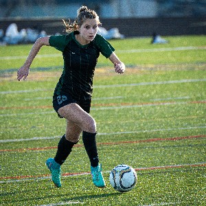 Girl running after soccer ball